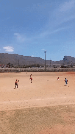 Baseball practice observed in rural Venezuela under mountain backdrop