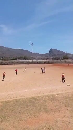 Baseball practice observed in rural Venezuela under mountain backdrop