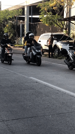 Afternoon traffic flows through a busy street in Boro, Indonesia