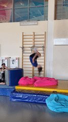 Children practice gymnastics jumps and backflips in Krasnoyarsk gymnasium