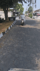 Morning street life across a historic Surakarta commercial district