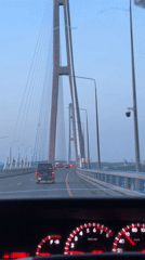 Vehicle crosses Russian flag-colored bridge to Russky Island