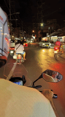 Motorcyclist rides through busy Patong streets at night