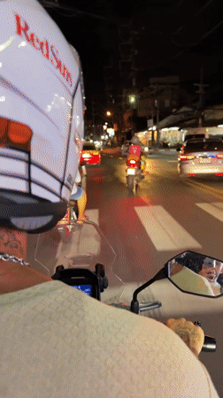 Motorcyclist rides through busy Patong streets at night