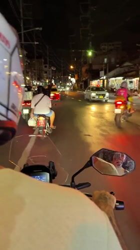Motorcyclist rides through busy Patong streets at night