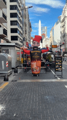 Buenos Aires street scene features inflatable ads near Obelisco