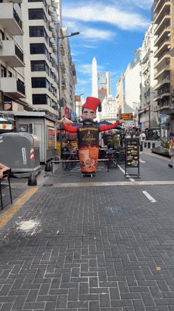 Buenos Aires street scene features inflatable ads near Obelisco