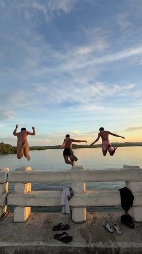 Bridge jumpers leap into water in General Luna Philippines
