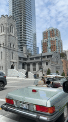 Woman in mint green convertible stops at Vancouver intersection