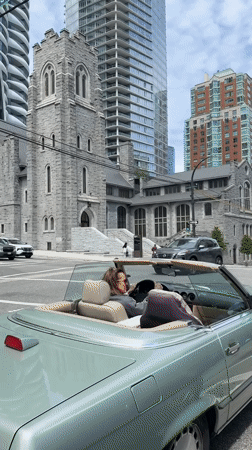Woman in mint green convertible stops at Vancouver intersection