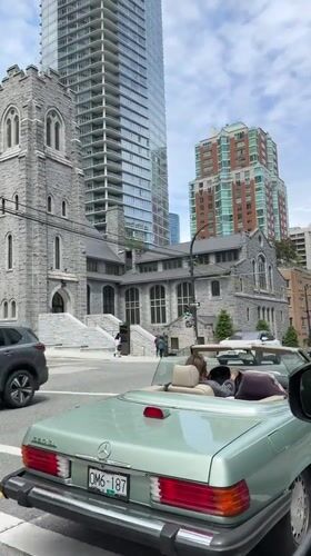 Woman in mint green convertible stops at Vancouver intersection