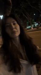 Woman walks at night in Nha Trang Ward