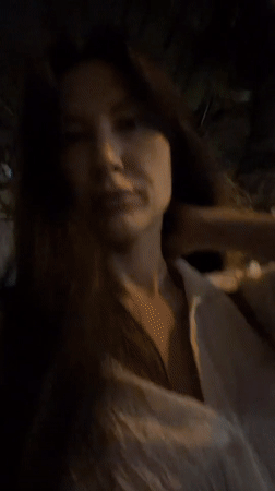 Woman walks at night in Nha Trang Ward