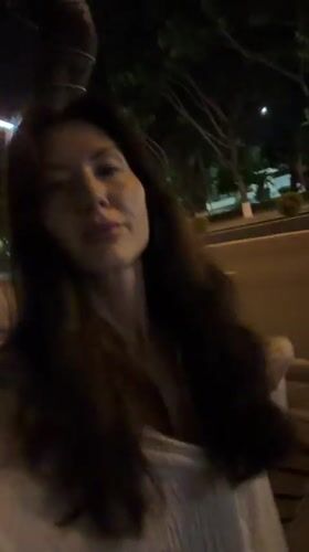 Woman walks at night in Nha Trang Ward
