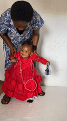 Woman and child interact in room in Bukuru
