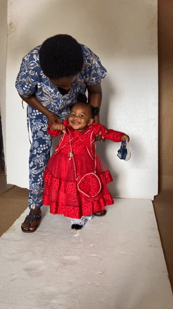Woman and child interact in room in Bukuru