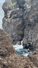 Tourists explore Porto Moniz volcanic pools under cloudy skies