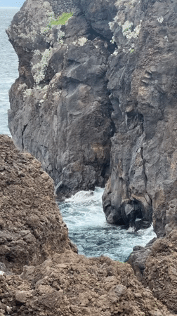 Tourists explore Porto Moniz volcanic pools under cloudy skies