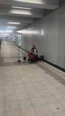 Street musician performs harp concert in Montreal subway tunnel