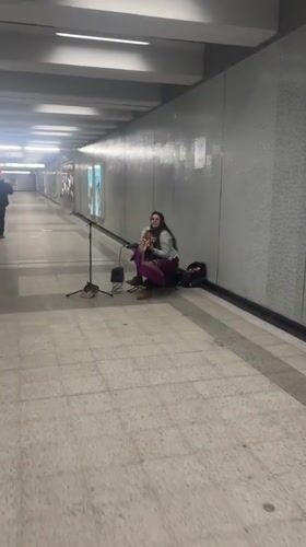 Street musician performs harp concert in Montreal subway tunnel