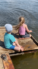 Children play on dock with dog in Votkinsk