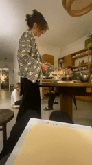 Woman serves wine to guests at Moscow gathering