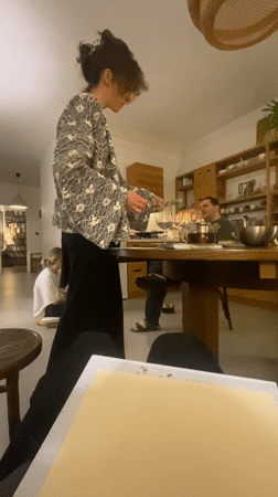 Woman serves wine to guests at Moscow gathering