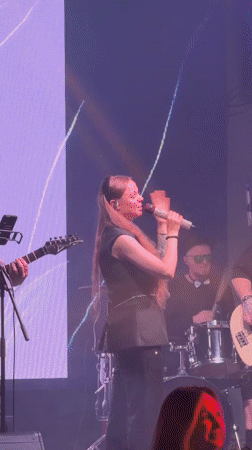 Red-haired performer takes stage in Krasnoyarsk wearing black outfit