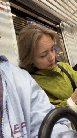 Commuter cleans hands with tissue on Tokyo train