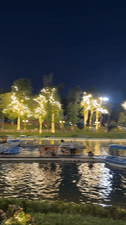 Magic City amusement park lit up at dusk in Tashkent
