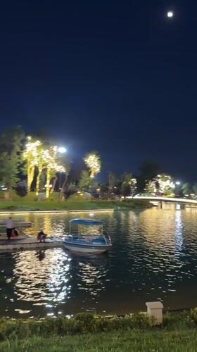 Magic City amusement park lit up at dusk in Tashkent