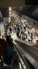 Londoners navigate transit stations and Canary Wharf during afternoon commute