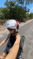 Motorcycle rider travels paved road in Mũi Né Vietnam
