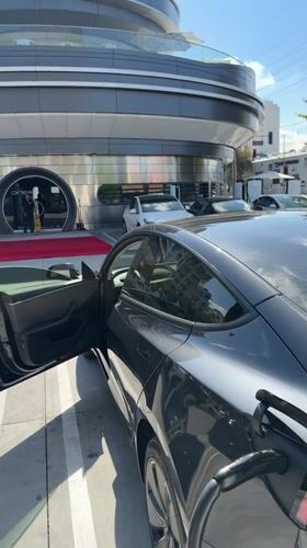 Tesla charging session documented outside modern West Hollywood building