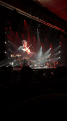 Orchestra performs with projected violinist close-ups in Almaty venue