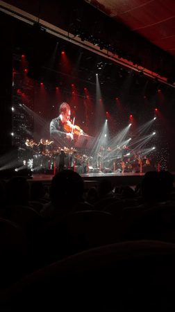Orchestra performs with projected violinist close-ups in Almaty venue