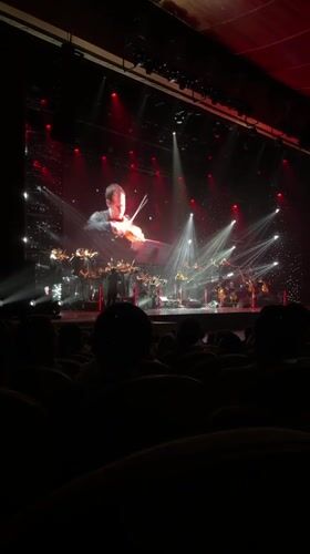 Orchestra performs with projected violinist close-ups in Almaty venue