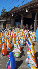 Rows of colorful inflatable penguins lined up in Baturiti