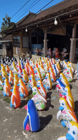 Rows of colorful inflatable penguins lined up in Baturiti
