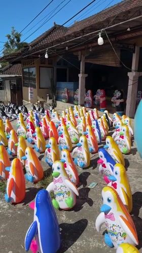 Rows of colorful inflatable penguins lined up in Baturiti