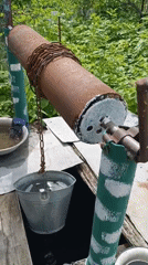 Morning water collection and meal at Russian village well