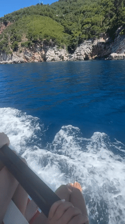 Relaxed boat ride along Montenegro's rugged green coastline