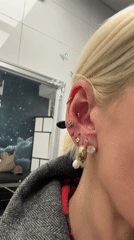 Woman with gold piercings visits Oslo shop or salon