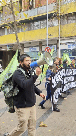 Man with megaphone speaks on Santiago street