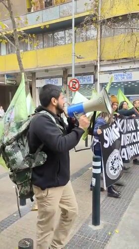 Man with megaphone speaks on Santiago street