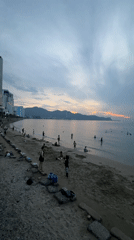 Nha Trang beachfront at dusk, promenade life winding into night