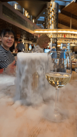 Woman dines at Sofia restaurant with chilled beverages