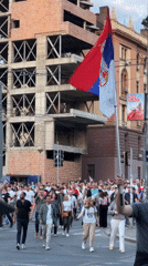 Crowd with Serbian flag crosses Belgrade streets