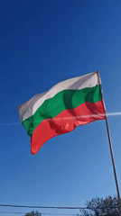 Bulgarian flag waves against blue sky in Sofia