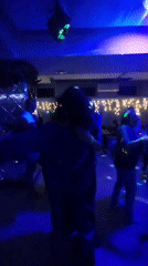Indoor party with dancing captured under colorful disco lighting